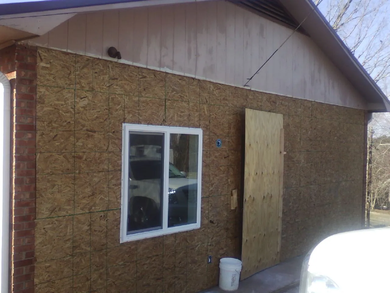 OSB sheathing on a garage addition wall before siding in Ephrata